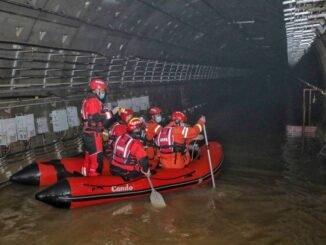 Bombeiros de bote em metrô inundado em Zhengzhou, na província chinesa de Henan Foto: STR / AFP